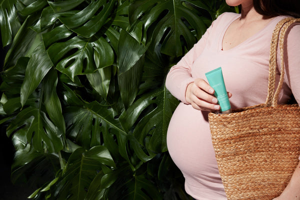 Pregnant woman with Squalane + Zinc Sheer Mineral Sunscreen